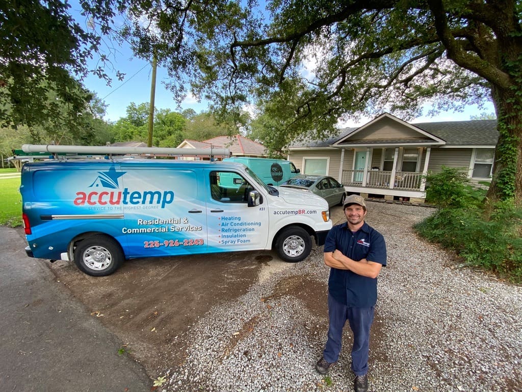 AccuTemp Employee standing outside his parked van