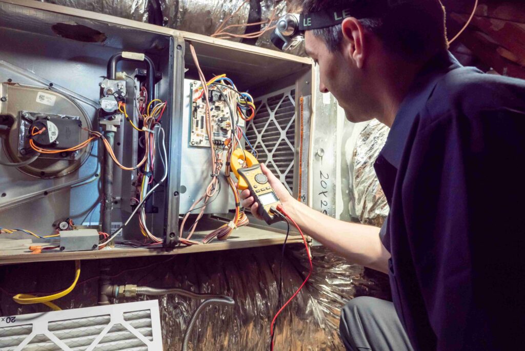 A Professional Fixing a Malfunctioning Furnace