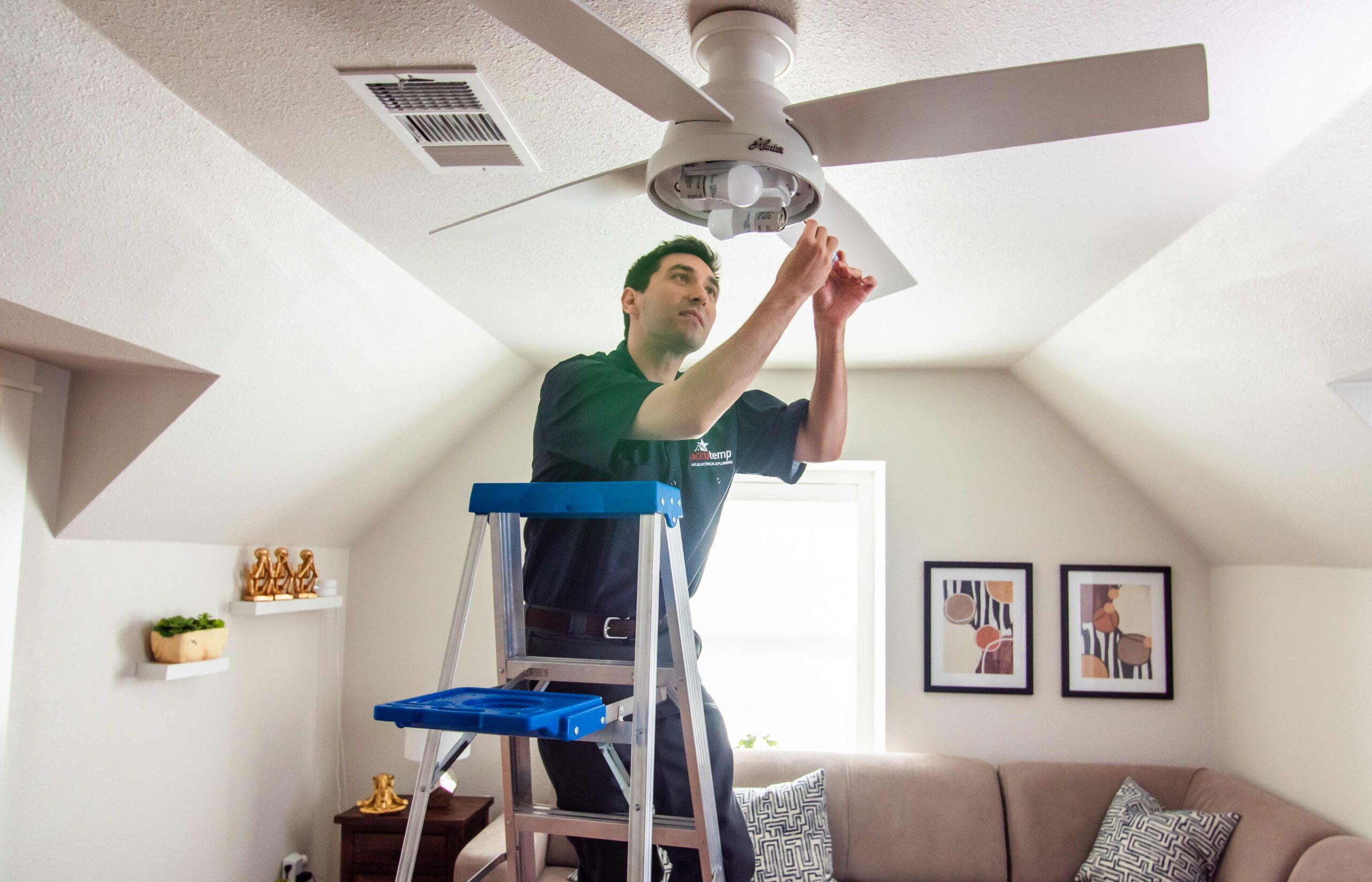 Electrician Installing a Ceiling Fan at a Customer Home in New Orleans, Louisiana